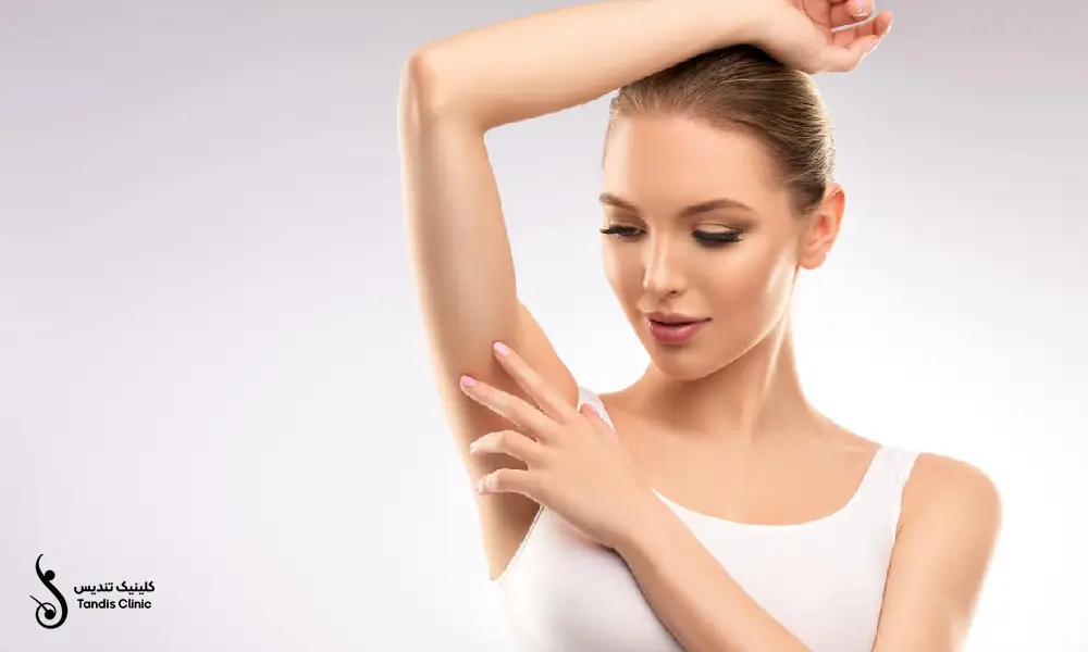 خانمی که نیم تنه ی سفید بر تن داردو یک دست خود را روی سرش گذاشته | لیزر موهای زائد زیر بغل